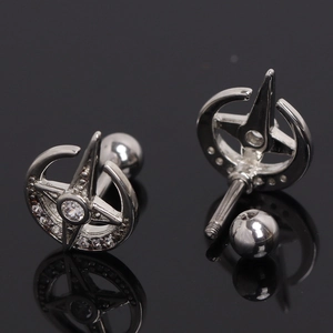 Stainless steel star and moon ear studs with sparkling cubic zirconia on black surface