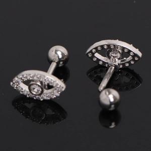 Evil eye stainless steel stud earrings with white zircons on black reflective background