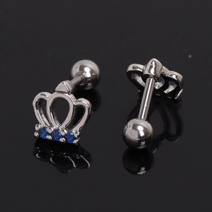 Pair of crown-shaped stainless steel stud earrings with blue gemstones on black background