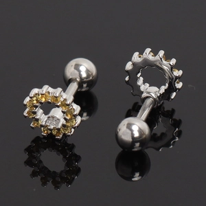 Vue macro de boucles d'oreilles fleur en argent avec zircons jaunes et vis de sécurité