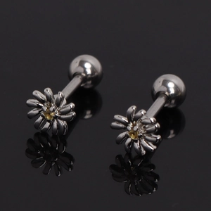 Pair of stainless steel daisy stud earrings with yellow crystals on black mirror background