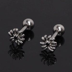 Detailed macro view of daisy stud earrings with black crystals and screw-back posts