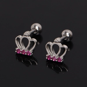Detailed macro view of silver crown stud earrings featuring sparkling pink zirconia gems