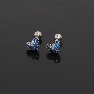 Close-up of heart-shaped steel studs with blue pave zircon and screw ball back