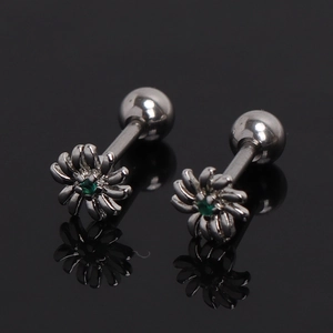 Detail of silver daisy flower studs with green center zircon and screw back closure