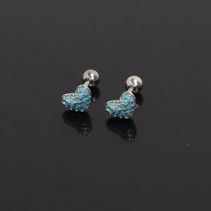Detail of heart stud earrings with blue beads on black reflective surface