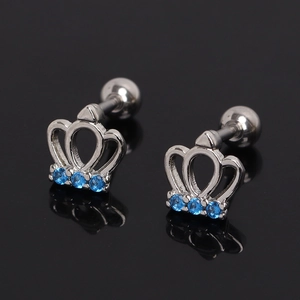 Macro detail of silver crown stud earrings with sparkling blue zircons and screw backs