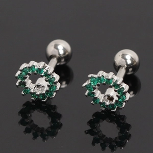 Détail du piercing cartilage en acier avec zircons verts et fermoir à boule vissée