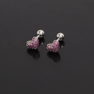 Macro view of heart cartilage studs with pink pavé zircons and ball screw backs
