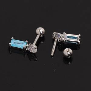 Macro shot of stainless steel stud earrings with blue rectangular stones and ball screw backs