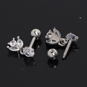 Macro shot of silver steel earrings with marquise zircon stones and screw-back closure
