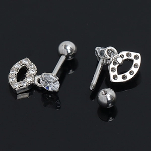 Close-up of silver stainless steel lip stud earrings with pavé set cubic zirconia crystals