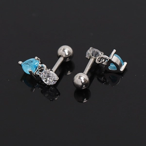 Detail of silver heart-shaped earrings with blue zircon and screw-back closure