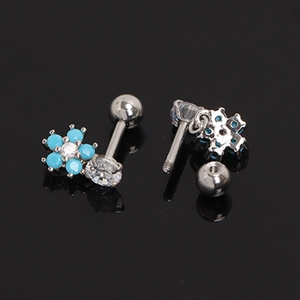 Macro view of stainless steel flower stud earrings with turquoise beads and screw back