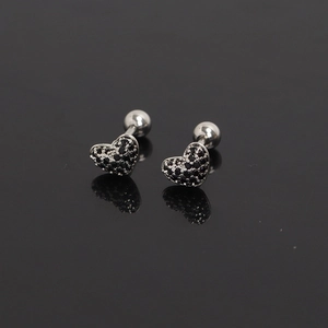 Close-up of heart-shaped steel stud earrings with black pavé crystals and screw backs
