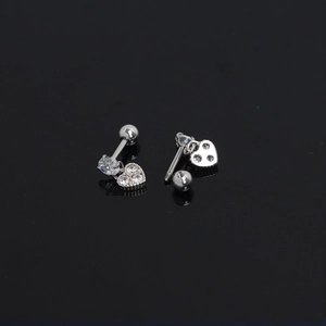 Detail of silver heart earring with screw back and sparkling zircon stones in macro view