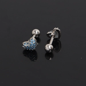 Detail of silver heart ear studs featuring deep blue zircon stones and screw-back balls