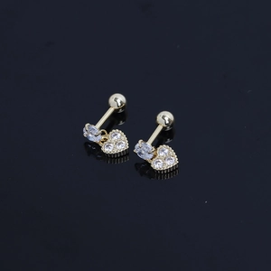 Elegant gold heart screw-back earrings with sparkling zircons on a reflective surface