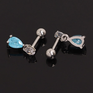 Macro detail of sapphire blue teardrop ear studs with white cubic zirconia accents