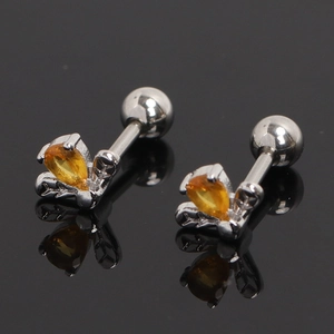 Silver barbell earrings with orange teardrop stone and leaf prongs on black mirror