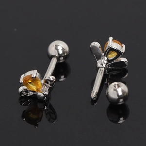 Macro detail of bee earrings with amber crystals and screw-back polished steel posts