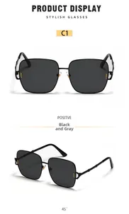 Detail of oversized square sunglasses with black metal frames and twisted metal temples