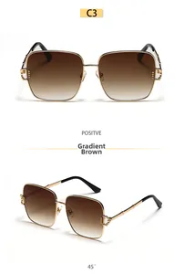 Detail view of large square gold metal sunglasses with gradient tea lenses and textured hinge