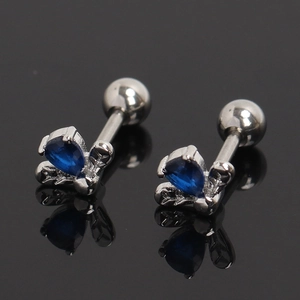 Detailed close-up of butterfly stud earring with blue zircon and screw back closure