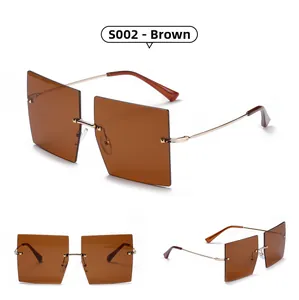 Detail view of tea-colored rimless oversized square sunglasses with gold metal temples