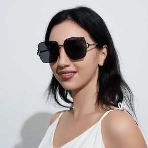Oversized square metal sunglasses with black lenses and geometric hollow temples on model