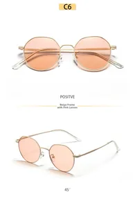 Detail of round beige metal frame sunglasses with pink lenses and wavy temples