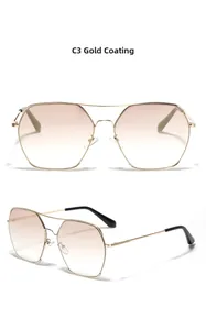 Macro detail of square metal sunglasses with gold plating and gradient brown lenses