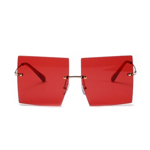 Modern oversized rimless square sunglasses with red lenses and gold metal rivets
