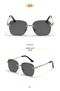 Detail of rimless square gold metal sunglasses with crystal accents and grey lenses