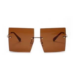 Oversized rimless square sunglasses with brown lenses and golden metal frames