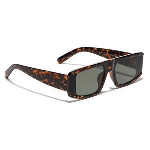 Y2K futuristic oversized tortoise shell sunglasses with dark lenses from a side angle
