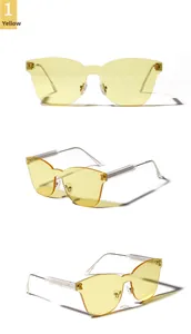 Three-way view of frameless yellow one-piece lens sunglasses with thin metal temples