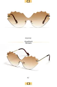 Detail of rimless wave-shaped sunglasses with gradient brown lenses and golden metal temples