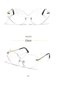 Detail view of cloud-shaped rimless sunglasses with wave-edge lenses and gold temples