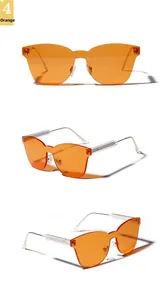 Detailed views of rimless orange cat-eye sunglasses with gradient lenses and silver temples