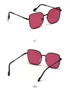 Detail view of oversized cat-eye sunglasses with metal frames and rose red lenses