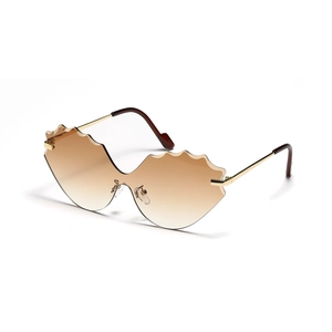 Cat eye rimless sunglasses with wavy brown gradient lenses and gold metal temples