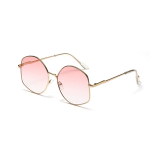 Oversized polygonal sunglasses with gold metal frame and pink gradient lenses