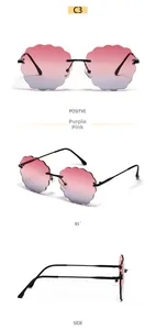 Detail of rimless wavy edge cloud sunglasses with purple-pink gradient lenses