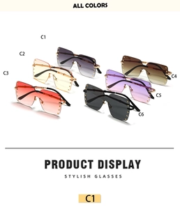 Detail display of rimless oversized square sunglasses with metallic rivet studs and gradient lenses
