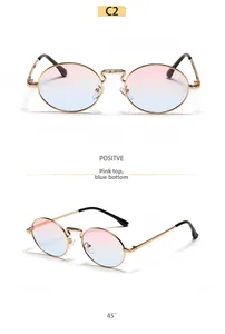 Detail view of oval metal sunglasses with pink to blue gradient lenses and gold frame
