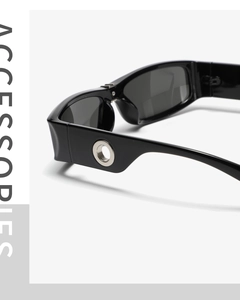 Detail view of wide temple sunglasses with silver metal ring hollow decoration