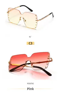 Detail view of oversized rimless square sunglasses with gold studs and gradient lenses