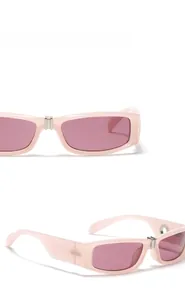 Macro shot of pink rectangular sunglasses showing silver bridge and CE marked temple arm