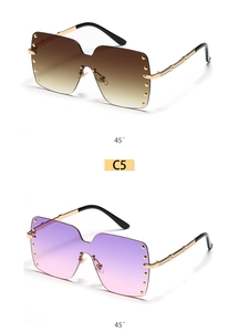 Detail view of oversized rimless square sunglasses with gold studs and bamboo metal temples